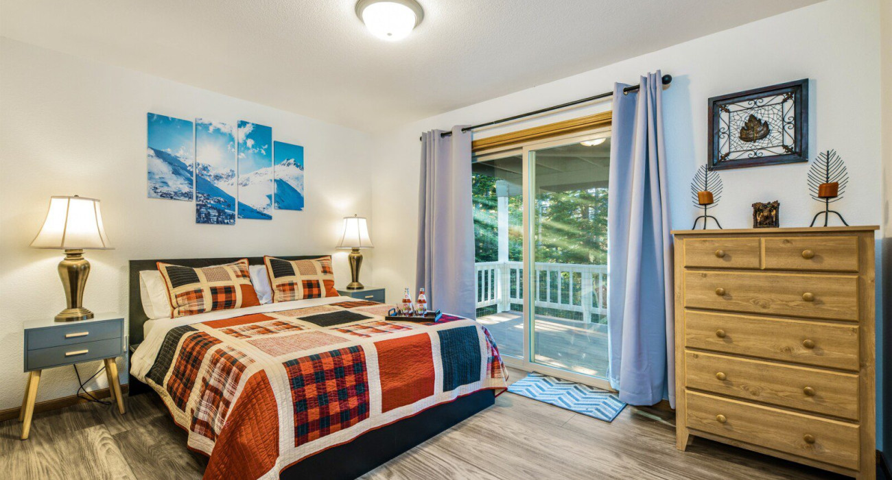 Cozy bedroom inside cabins near hiking trails Lake Tahoe with warm lighting, wood interior design, and a peaceful mountain cabin atmosphere.